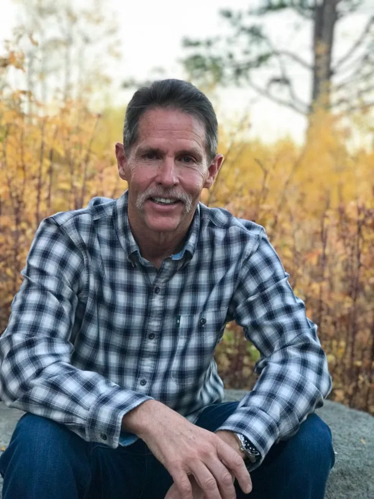 Portrait of Dr. Tim Schroeder outdoors among autumn aspens in Tahoe City, California